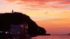 Qihou Lighthouse at sunset with colorful clouds