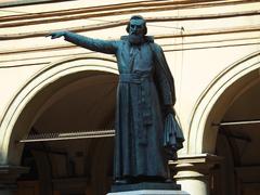 Statue of Ugo Bassi under Italian porticoes