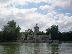 El Retiro Park in daylight with people walking along the path