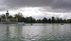 Main pond of Retiro Park in Madrid with Alfonso XII monument in the background