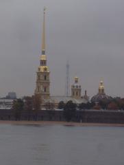 St Peter and Paul fortress towers on a cloudy day by the Neva River