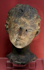 ancient statue of a child's head and arm from the 2nd century on display at La Tutela Tricolore exhibition