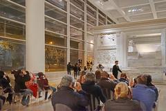 Visitors with virtual and augmented reality headsets in front of the Ara Pacis