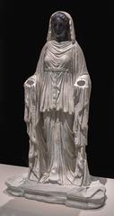 Ancient marble figure of a possible priestess with white body and black head