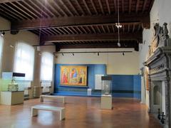 A room in the State Museum of Medieval and Modern Art in Italy, showcasing sculptures and paintings