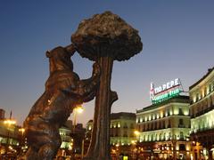 Statue by Antonio Navarro Santafe in Madrid with the Tio Pepe Neon Advertisement in the background