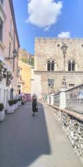 Taormina packed with tourists on a late summer's morning with Palazzo Corvaja in the background