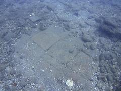 underwater view of a submerged thermal bath complex structure with mosaic flooring