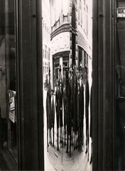 Gabinio photographing a group of onlookers reflected in a curved shop window in Piazza C.L.N., Torino