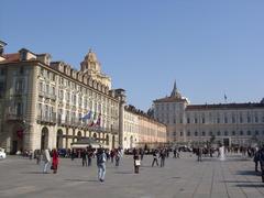 Piazza Castello in Torino with historic buildings and people walking