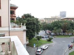 A panoramic view of Genoa, Italy with vibrant buildings and the harbor