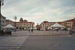 Cuneo central square with historic buildings and a market setup