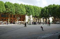 Lucca Piazza Napoleone with historic buildings and people