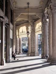 street musician and his dog under the arcades of Via Cernaia in Turin on a sunny November morning