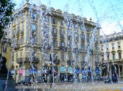 Piazza Solferino in Turin, Italy, featuring a large central fountain and well-maintained greenery