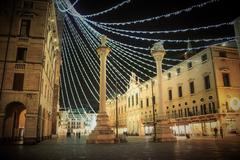 Monument adorned with luminarie lights in Piazza dei Signori, Italy