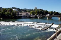 Diga Michelotti dam in Turin viewed from the north with Vittorio Emanuele I bridge and Monte dei Cappuccini in the background.