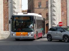 Bus passing through Camolia city gate in Siena