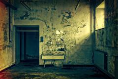 Sepia-toned abandoned room with a door, bench, and decaying wall