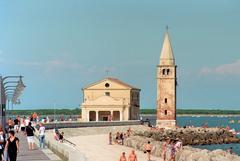 a picturesque view of Caorle, Italy, with colorful buildings and a waterfront