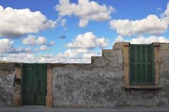 Abandoned old house in a field with blue sky