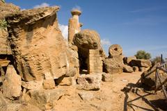 Ancient Greek Temple of Heracles ruins under a clear blue sky in Agrigento, Sicily