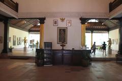 Front room of Agung Rai Museum of Art with a reception desk and displayed artworks