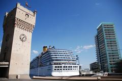 The Torretta clock tower in the Port of Savona with Costa Atlantica cruise ship in the background