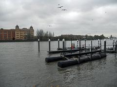 Thames jetty with calm waters and a cloudy sky