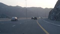 Fujairah Dubai Road in UAE with vehicles and mountains in the background