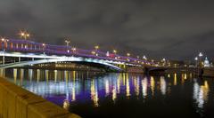 Bolshoy Ustynsky bridge in Moscow at night with city lights reflecting on the river