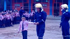 A firefighter educating a child about fire safety