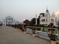 A scenic pond inside Chota Imambara with surrounding greenery and architectural elements