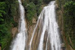 Kempty Falls surrounded by high mountain ranges in Dehradun, Uttarakhand