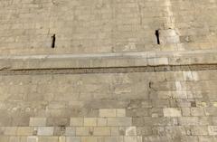 Kufic inscription carved in stone on the city wall next to Bab al-Futuh