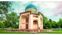 Nili Chhatri Tomb with white marble facade and chhatri design against a cloud-streaked blue sky