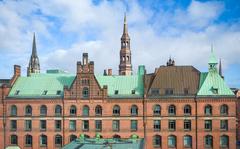 Historic warehouse district of Hamburg harbor with St. Catherine’s Church and St. Nicholas Church in the background