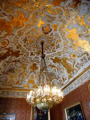 Rococo stuccoes and 19th century chandelier in Queen's room at Royal Palace of Naples