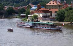 Vltava River and steamship in Prague, Czech Republic, with Franz Kafka Museum in the background