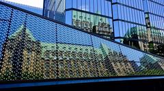 reflection of parliament buildings in Bank of Canada and Currency Museum buildings