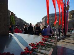 Victory Day parade in Saint Petersburg featuring the Immortal Regiment at Nevsky Prospekt and Vosstaniya Square with the Hero City Obelisk in the background