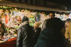 Christmas markets of Trento at night with illuminated stalls and a large Christmas tree