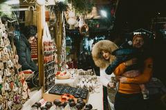 Christmas markets of Trento at night with festive lights and decorated stalls