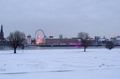 Snow-covered Rheinwiese in Düsseldorf-Oberkassel with a view of the Düsseldorf old town