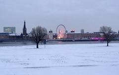 snow-covered Rheinwiese in Düsseldorf-Oberkassel with a view of the Düsseldorf Old Town