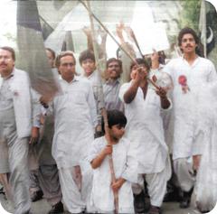 4-year-old Fraz Wahlah holding Peoples Party flag during MRD protest in Punjab, Pakistan.