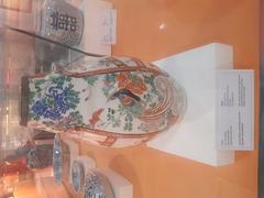 18th century porcelain vase with floral motifs, human figures, and compound wall designs