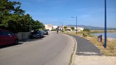 View from Avenue des Tamarins with Étang de la Franqui on the right and the Corbières mountain range in the background