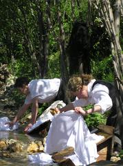 women washing clothes by river