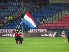 Wisła Kraków fans with a giant dragon flag during UEFA Champions League qualifying match